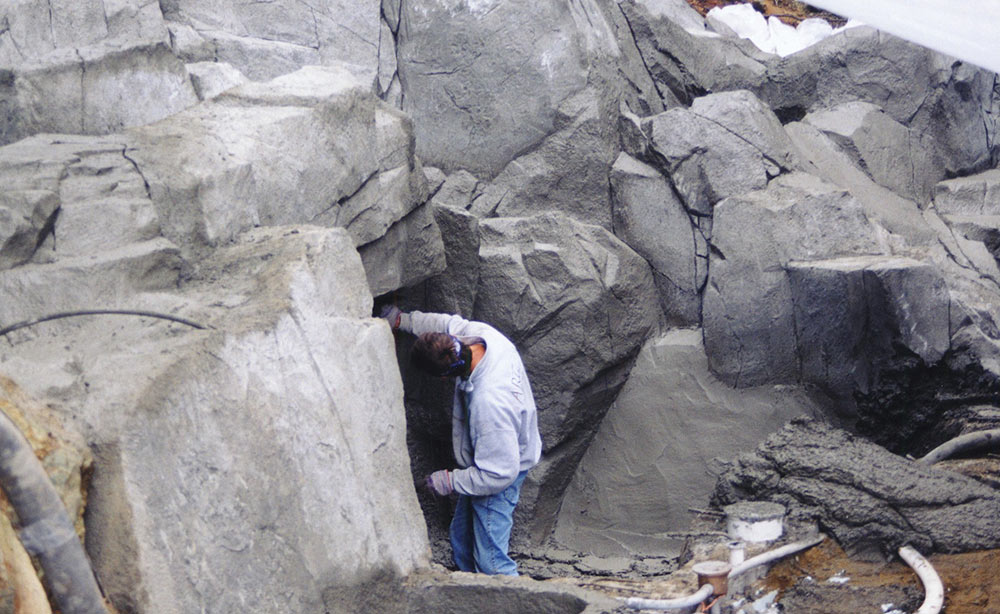 Carving custom rockwork for a swimming pool.