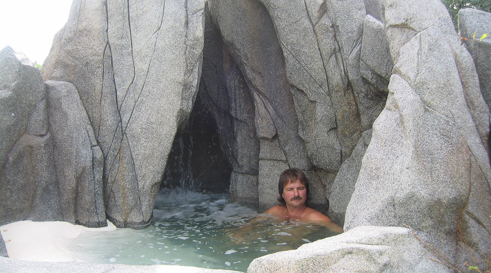 Peter inspecting his work with waterfall in the background