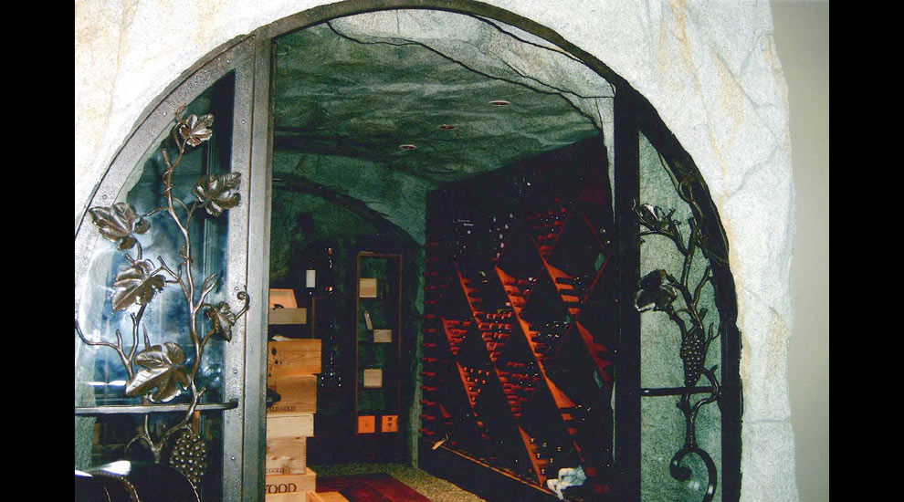 Custom Wine Cellar integrating wrought iron and rockwork.