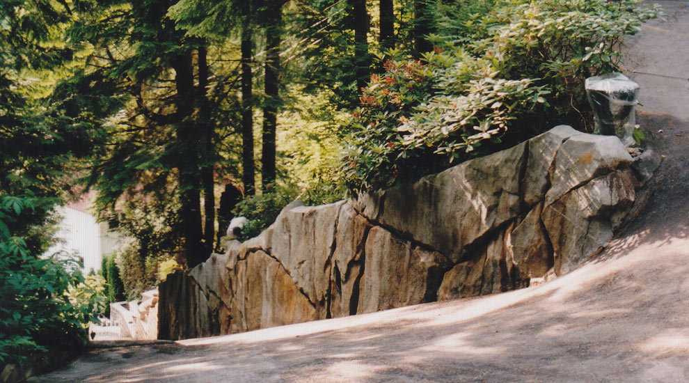 Artifical rockwork used to good effect as a retaining wall on a steep driveway.